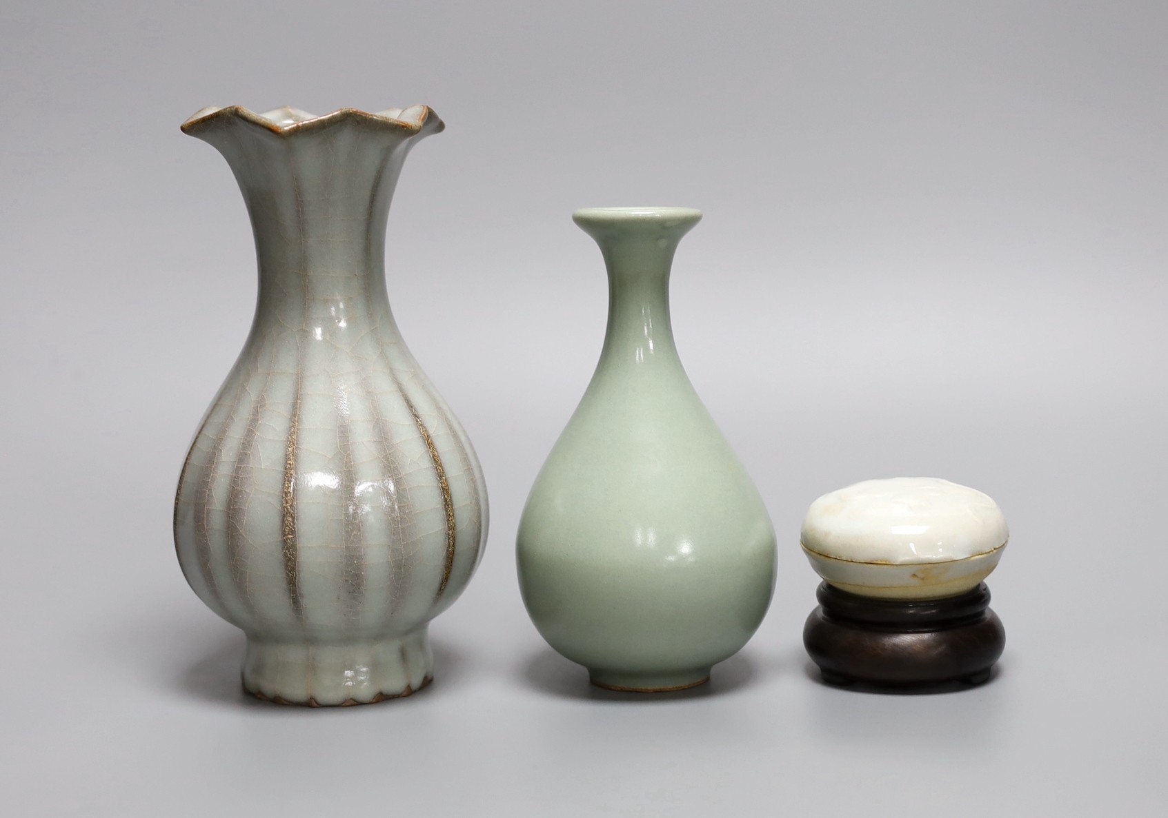 A Chinese celadon ground bottle vase, a similar crackle glazed vase, a paste box with cover and stand, tallest 16cm